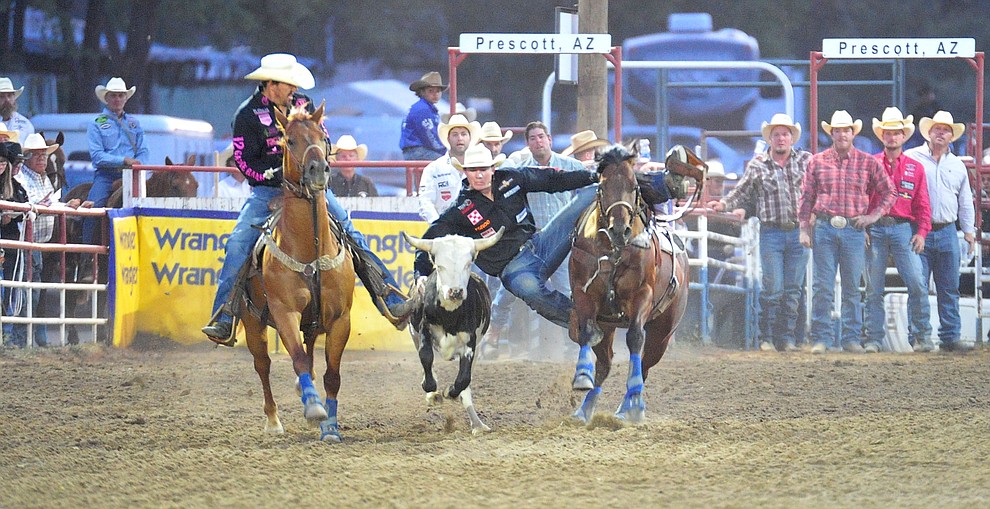 Ty Erickson has a 4.3 second run in the steer wrestling during the 5th performance of the Prescott Frontier Days Rodeo at the Prescott Rodeo grounds Friday July 5, 2019. (Les Stukenberg/Courier)