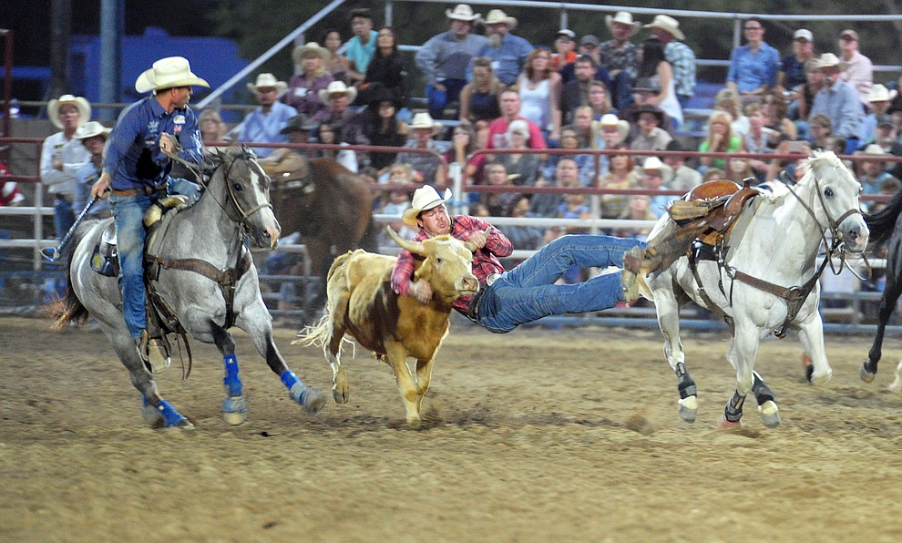 Jacob Edler has a 6.3 second run in the steer wrestling during the 5th performance of the Prescott Frontier Days Rodeo at the Prescott Rodeo grounds Friday July 5, 2019. (Les Stukenberg/Courier)
