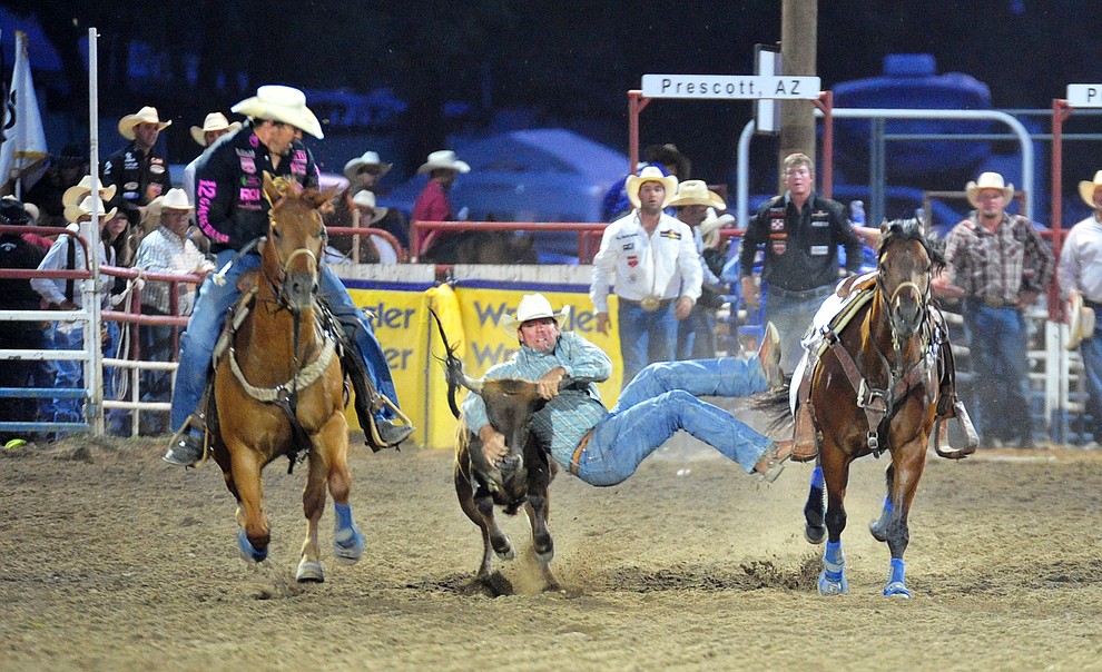 TJ Hall has a 4.9 second run in the steer wrestling during the 5th performance of the Prescott Frontier Days Rodeo at the Prescott Rodeo grounds Friday July 5, 2019. (Les Stukenberg/Courier)