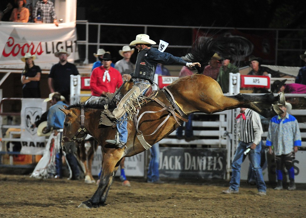 D.J. Stoneburner scores 77 on Dakota Babe in the saddle bronc during the 5th performance of the Prescott Frontier Days Rodeo at the Prescott Rodeo grounds Friday July 5, 2019. (Les Stukenberg/Courier)