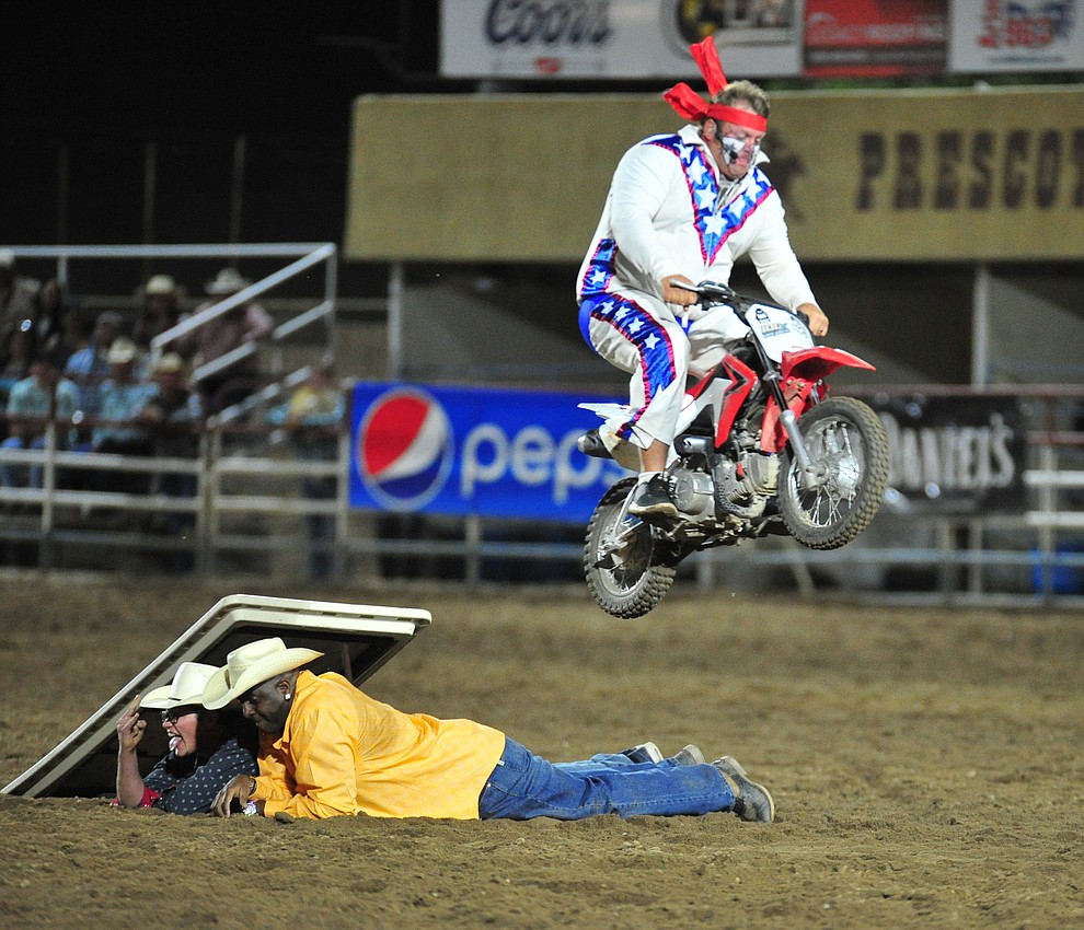 Justin Rumford jumps a couple of "volunteers" during the 5th performance of the Prescott Frontier Days Rodeo at the Prescott Rodeo grounds Friday July 5, 2019. (Les Stukenberg/Courier)