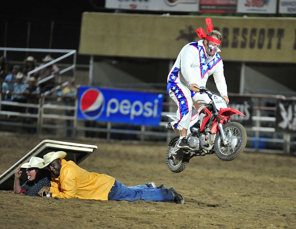 Justin Rumford jumps a couple of "volunteers" during the 5th performance of the Prescott Frontier Days Rodeo at the Prescott Rodeo grounds Friday July 5, 2019. (Les Stukenberg/Courier)