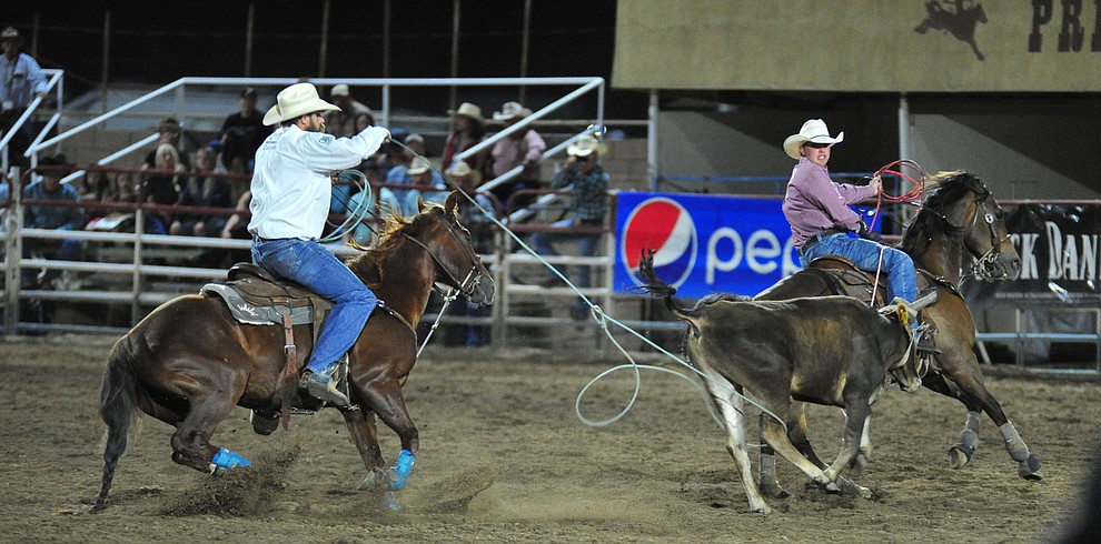 Kolton Schmidt and Jeremy Buhler have a 6.9 second run in the team roping during the 5th performance of the Prescott Frontier Days Rodeo at the Prescott Rodeo grounds Friday July 5, 2019. (Les Stukenberg/Courier)