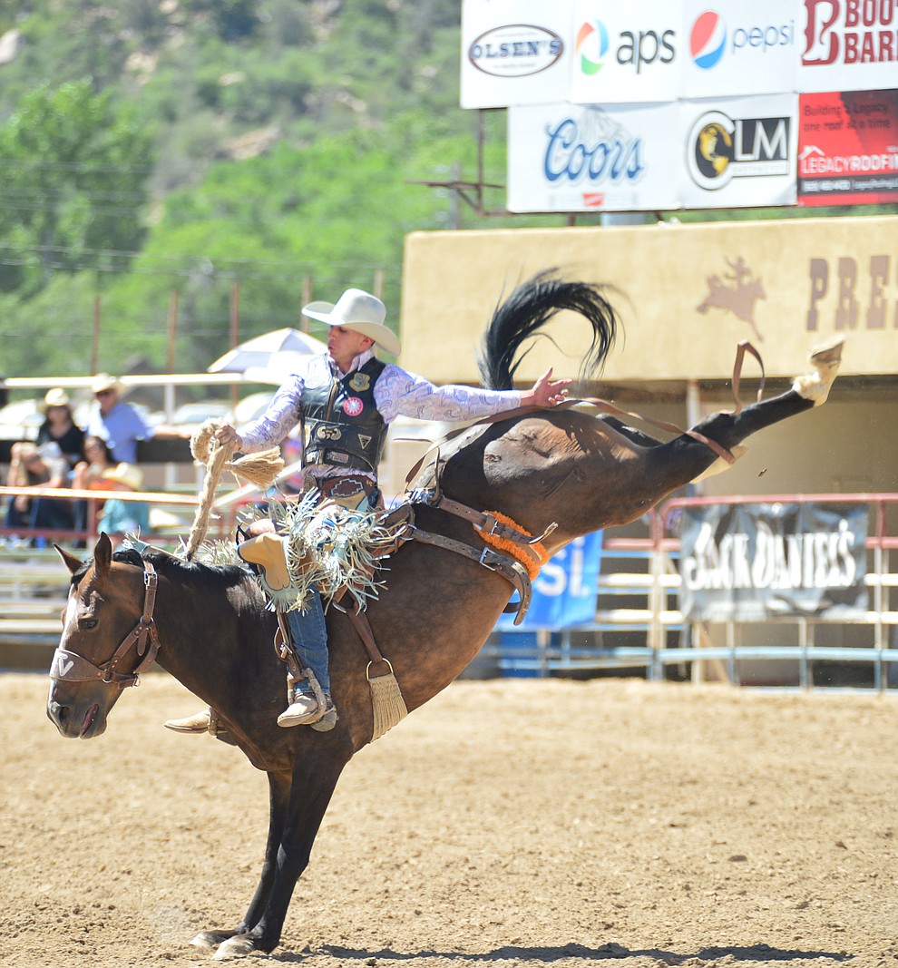 Reed Neely scores 66 on Joker in the saddle bronc riding during the 6th performance of the Prescott Frontier Days Rodeo Saturday afternoon July 6, 2019. (Les Stukenberg/Courier)