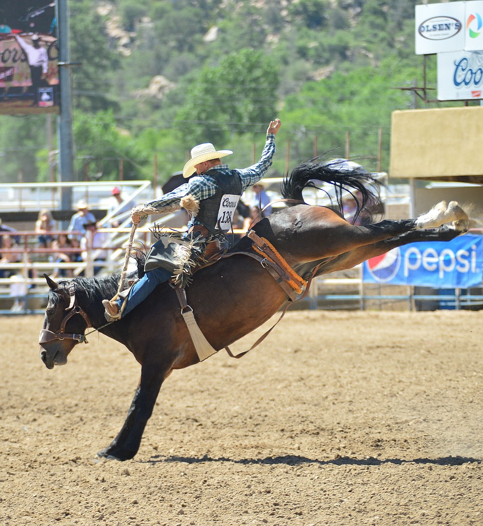 Tim Ditrich scores 82 on Gummi Bear in the saddle bronc riding during the 6th performance of the Prescott Frontier Days Rodeo Saturday afternoon July 6, 2019. (Les Stukenberg/Courier)