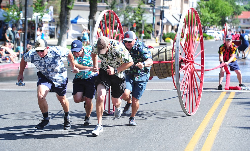 A team from Central Arizona Fire and Medical compete during the annual Hose Cart Races Sunday July 7, 2019 on Cortez Street in Prescott. The event has a history from the earliest days of the Prescott Fire Department when it was manned by volunteers. In the current version the competition has been going on for at least 70 years. (Les Stukenberg/Courier)