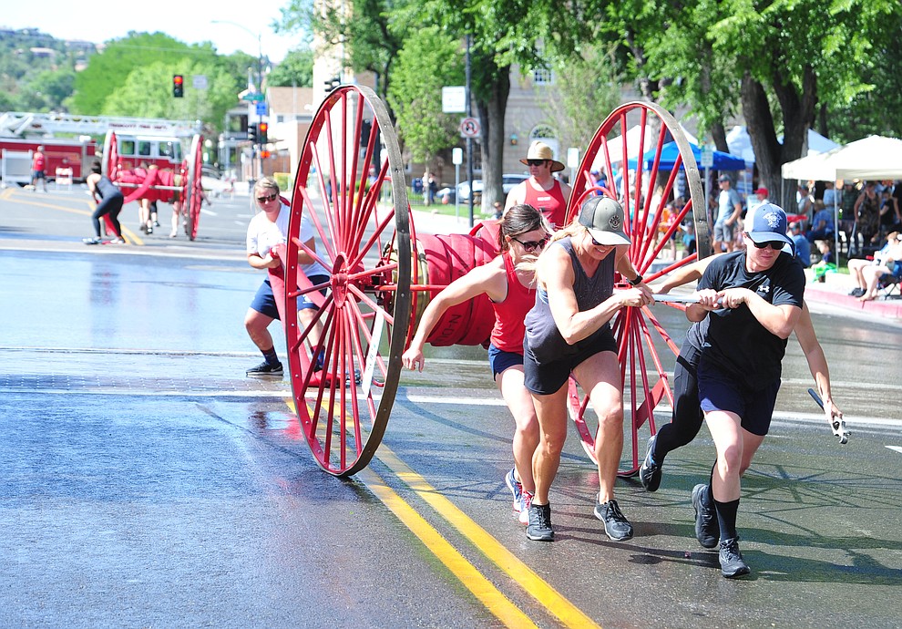 A team of all female firefighters, the first time ever, competes during the annual Hose Cart Races Sunday July 7, 2019 on Cortez Street in Prescott. The event has a history from the earliest days of the Prescott Fire Department when it was manned by volunteers. In the current version the competition has been going on for at least 70 years. (Les Stukenberg/Courier)