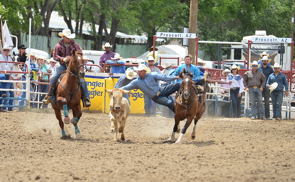 Kodie Jang has a 7.4 second run in the steer wrestling during the final performance of the Prescott Frontier Days Rodeo Sunday July 7, 2019. (Les Stukenberg/Courier)