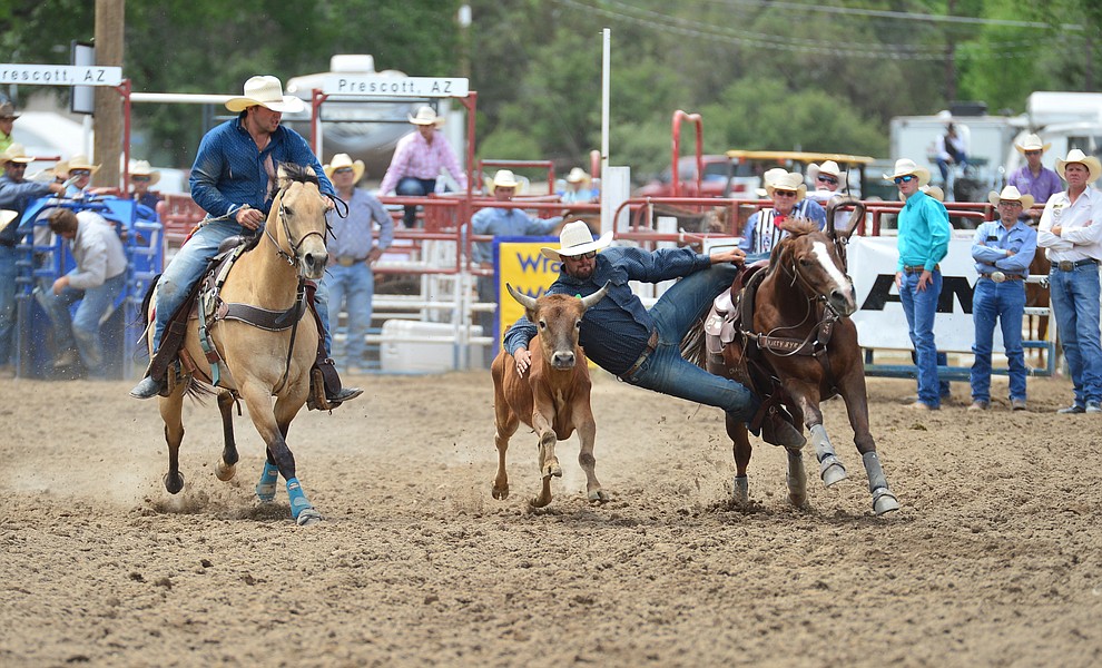 Justin Rockhill has an 8.8 secod run in the steer wrestling during the final performance of the Prescott Frontier Days Rodeo Sunday July 7, 2019. (Les Stukenberg/Courier)