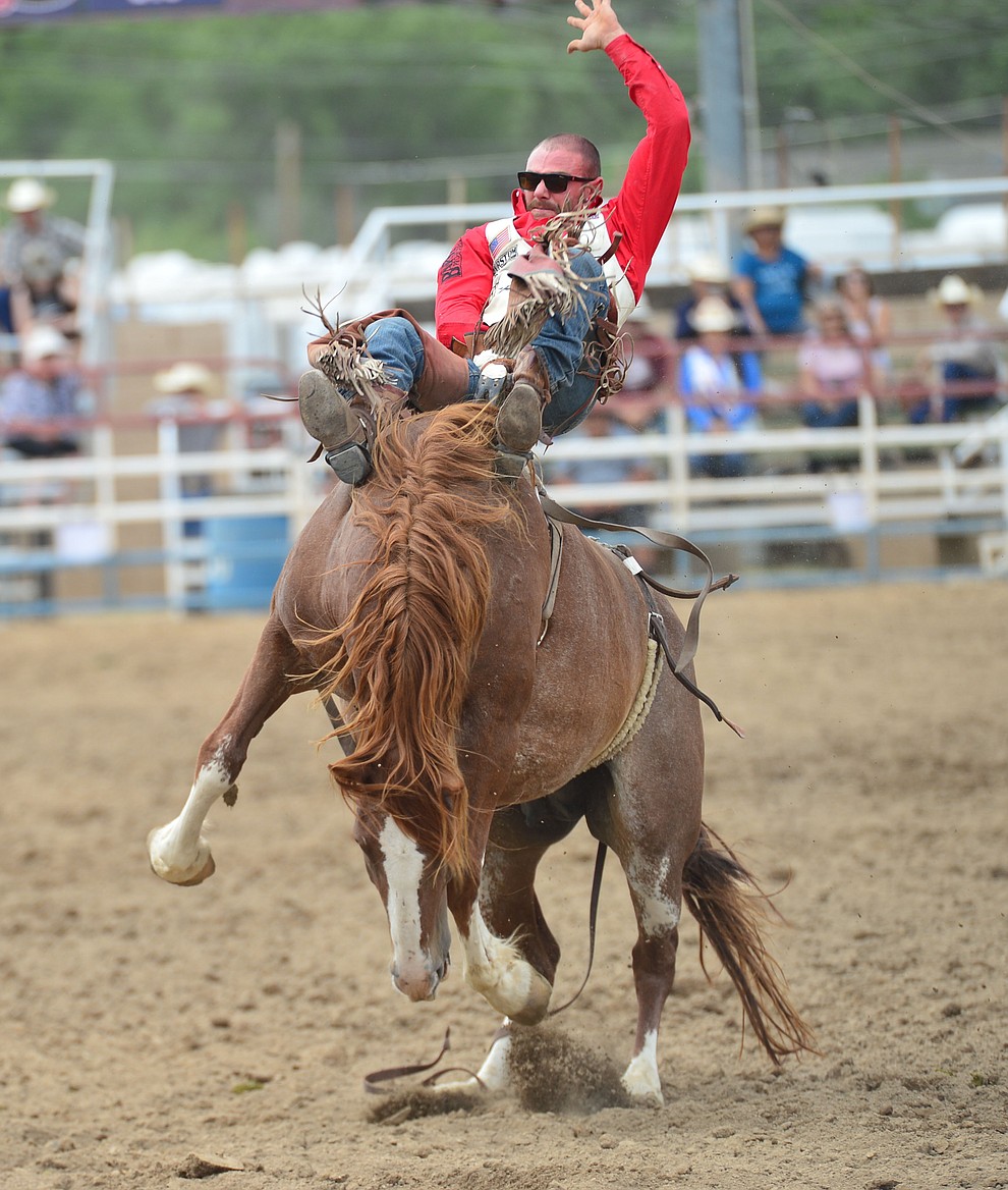 Mason Clements rides Buckle Up for 81.5 points in the bareback riding during the final performance of the Prescott Frontier Days Rodeo Sunday July 7, 2019. (Les Stukenberg/Courier)