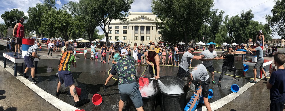 It's Central Arizona Fire versus Peoria Fire in the bucket brigade during the annual Hose Cart Races Sunday July 7, 2019 on Cortez Street in Prescott. (Les Stukenberg/Courier)