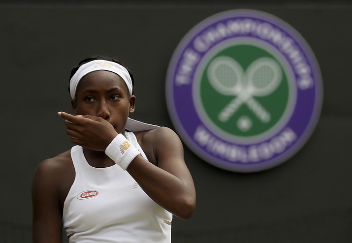 United States' Cori "Coco" Gauff wipes her face during a women's singles match against Romania's Simona Halep on day seven of the Wimbledon Tennis Championships in London, Monday, July 8, 2019. (Kirsty Wigglesworth/AP)