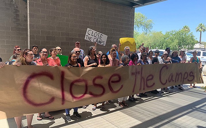 Protesters gathered outside U.S. Rep. Greg Stanton’s Phoenix office demanding the closure of immigrant detention centers. A nationwide immigration enforcement operation targeting people who are in the United States illegally is expected to begin this weekend. (Photo by Amanda Slee/Cronkite News)