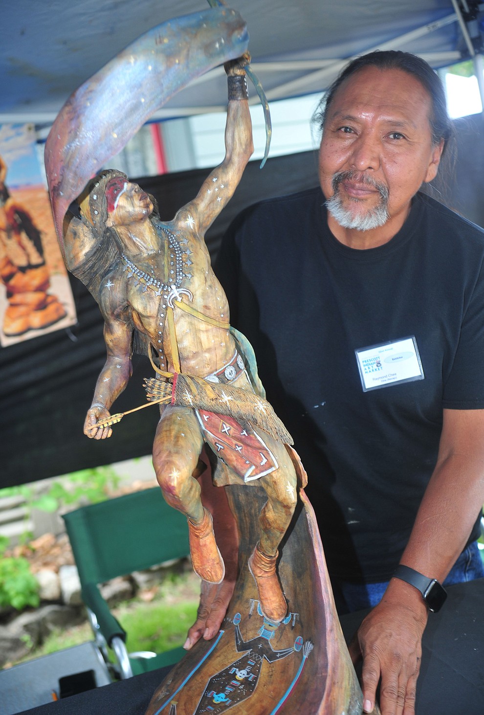 Raymond Chee poses with his sculture reminiscent of Orionat the Prescott Indian Arts Market at the Sharlot Hall Museum Saturday July 13. For a short video of the event go to dCourier.com. The show continues Sunday, July 14. (Les Stukenberg/Courier)
