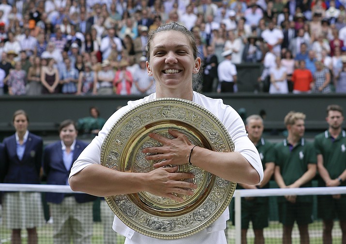 Romania's Simona Halep poses with the trophy after defeating United States' Serena Williams during the women's singles final on day 12 of the Wimbledon Championships in London, Saturday, July 13, 2019. (Kirsty Wigglesworth/AP)