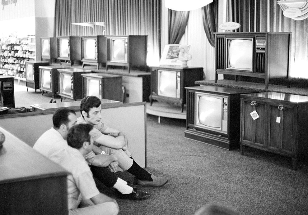 FILE - In this July 16, 1969 file photo, people watch the Apollo 11 Saturn V rocket launch on multiple TV's at a Sears department store in White Plains, N.Y. (AP Photo/Ron Frehm, File)