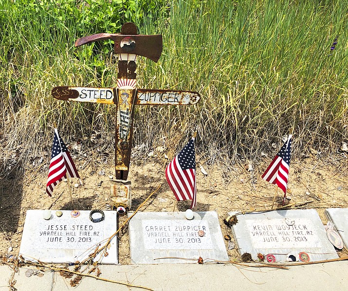 Memorial stones can be seen at the Wildland Firefighters Monument at the National Interagency Fire Center in Boise, Idaho, for wildland firefighters killed by a wildfire on June 30, 2013, near Yarnell, Arizona. Federal officials at the NIFC are bolstering mental health resources for wildland firefighters following an apparent increase in suicides. (AP Photo/Keith Ridler)