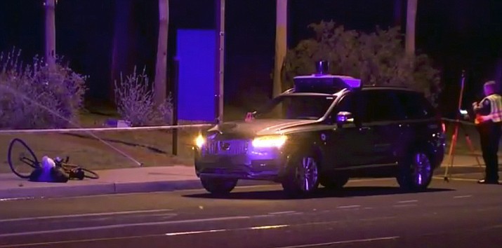 In this March 19, 2018, file image taken from video provided by ABC-15, an investigators works at the scene of a fatal accident involving a self driving Uber car in Tempe, Ariz. Police outside Phoenix recently closed part of a street to conduct a lighting test as an investigation continues into the 2018 death of a woman who was struck and killed by an Uber self-driving SUV. The Maricopa County Attorney s Office says prosecutors asked for more investigation before making a decision about whether to charge backup driver Rafaela Vasquez who was supposed to take control in an emergency. Another prosecutor s office decided in March not to charge Uber. (ABC-15.com via AP)