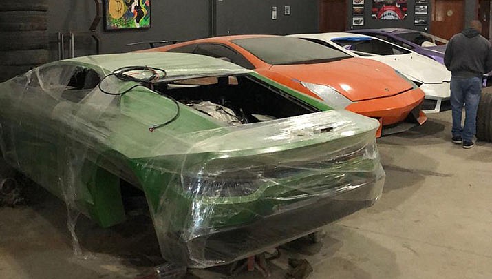 This photo released by Itajai Civil Police, shows car molds of luxury car replicas at a workshop in Itajai, Brazil. (Itajai Civil Police via AP)