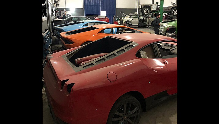 This photo released by Itajai Civil Police shows luxury car replicas inside a workshop in Itajai, Brazil. (Itajai Civil Police via AP)