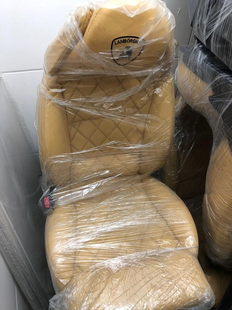 This photo released by Itajai Civil Police shows the seat of a car embroidered with a fake Lamborghini logo, inside a workshop in Itajai, Brazil. (Itajai Civil Police via AP)