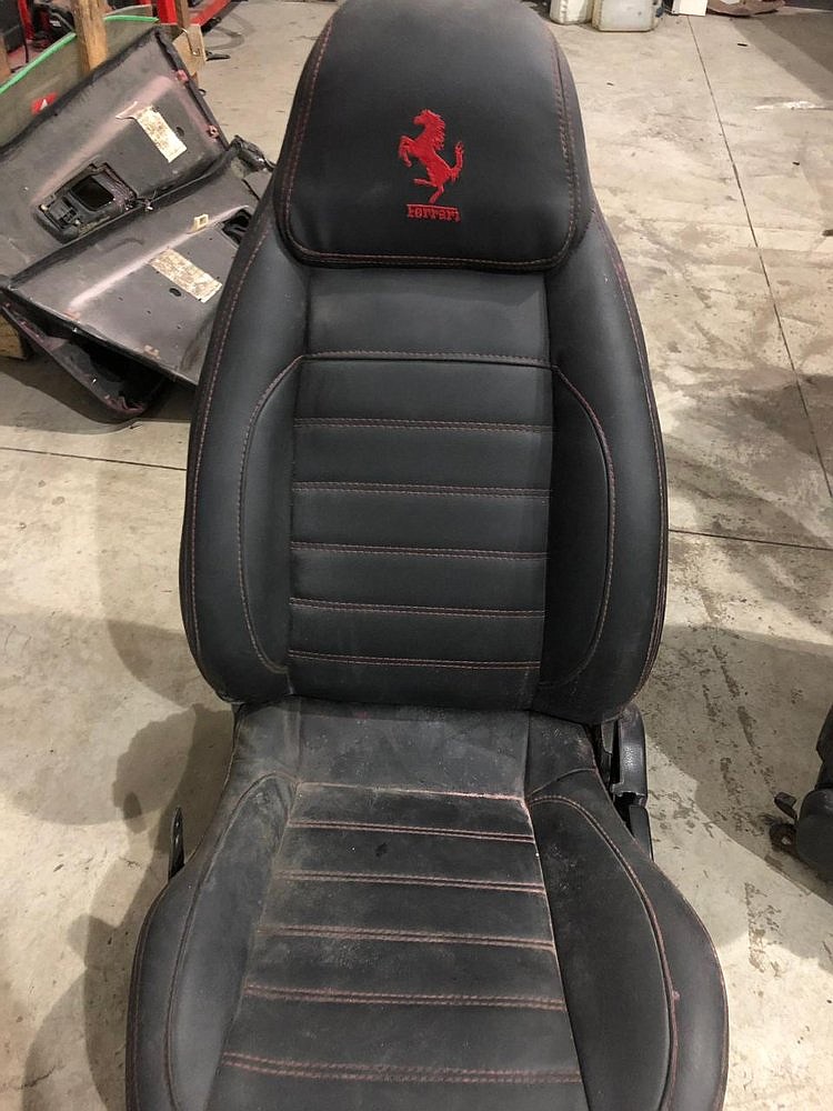 This photo released by Itajai Civil Police shows the seat of a car embroidered with a fake Ferrari logo, inside a workshop in Itajai, Brazil. (Itajai Civil Police via AP)