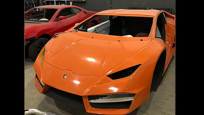 This photo released by Itajai Civil Police shows luxury car replicas inside a workshop in Itajai, Brazil. (Itajai Civil Police via AP)
