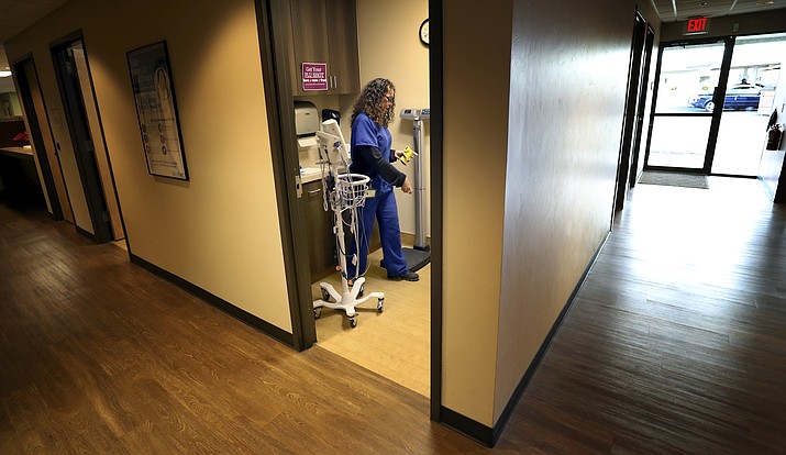 In this July 10, 2019 photo, medical assistant Angelica Hall gives a patient a breathalyzer test at CODAC in Tucson, Ariz., near a door the facility has recently opened for use exclusively for Tucson Police Officers bringing people to the facility suspected of abusing opioids. (Kelly Presnell/Arizona Daily Star via AP)