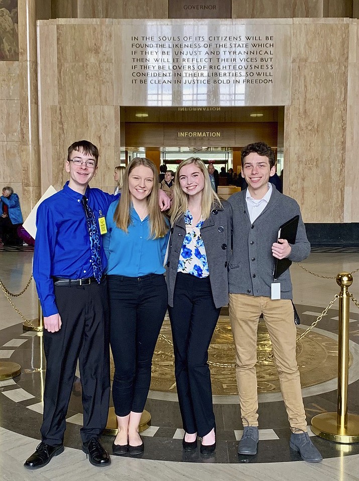 In this Feb. 6, 2019 photo provided by Providence Health & Services, from left, Sam Adamson, Lori Riddle, Hailey Hardcastle, and Derek Evans pose at the Oregon State Capitol in Salem, Ore. The teens introduced legislation to allow students to take "mental health days" as they would sick days in an attempt to respond to a mental health crisis gripping the state. (Jessica Adamson/Providence Health & Services via AP)