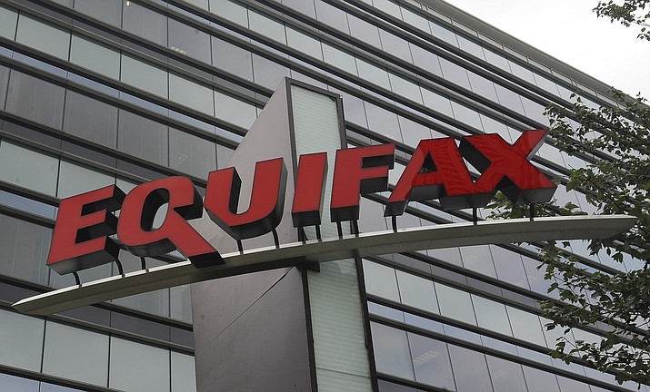 This July 21, 2012, file photo shows signage at the corporate headquarters of Equifax Inc., in Atlanta. Equifax will pay up to $700 million to settle with the Federal Trade Commission and others over a 2017 data breach that exposed Social Security numbers and other private information of nearly 150 million people. The proposed settlement with the Consumer Financial Protection Bureau, if approved by the federal district court Northern District of Georgia, will provide up to $425 million in monetary relief to consumers, a $100 million civil money penalty, and other relief. (Mike Stewart/AP, File)