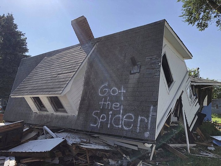 On Monday, July 15, 2019, a Renner, South Dakota couple spray painted the side of their second house after they tore it down with "Got the Spider!" as a joke, Friday, July 19, 2019. The photo has since gone viral with more than 47,000 shares on Facebook. (Makenzie Huber/The Argus Leader via AP)