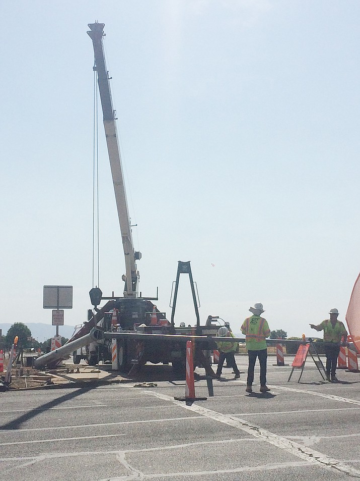 A crew was working to raise the new traffic signal at Glassford Hill Road and Lakeshore Drive in Prescott Valley on Monday morning, July 22. The project is 99% complete, town officials said Monday evening. (Tim Wiederaenders/Courier)