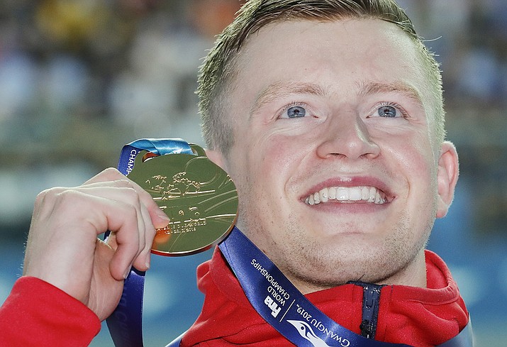 Adam Peaty holds up his gold medal after winning the men’s 100m breaststroke final at the World Swimming Championships in Gwangju, South Korea, Monday, July 22, 2019. (Lee Jin-man/AP)