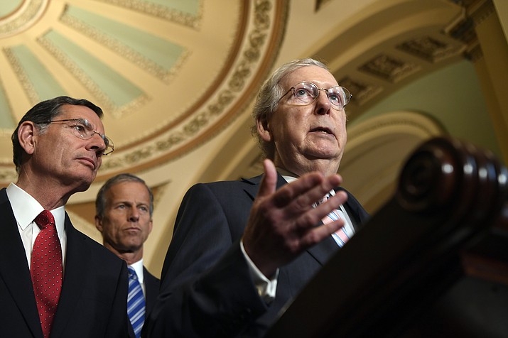 Senate Majority Leader Mitch McConnell of Ky., right, joined by Sen. John Barrasso, R-Wyo., left, and Sen John Thune, R-S.D., center, speaks to reporters following the weekly policy lunches on Capitol Hill in Washington, Tuesday, July 23, 2019. (AP Photo/Susan Walsh)