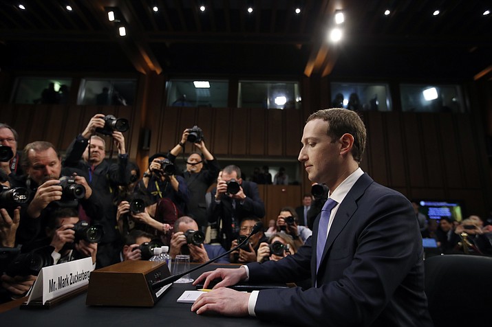 FILE - In this April 10, 2018, file photo Facebook CEO Mark Zuckerberg takes his seat to testify before a joint hearing of the Commerce and Judiciary Committees on Capitol Hill in Washington. The Washington Post reported on Tuesday, July 23, 2019, that the Federal Trade Commission will allege that Facebook misled users about its privacy practices as part of an expected settlement.(AP Photo/Alex Brandon, File)