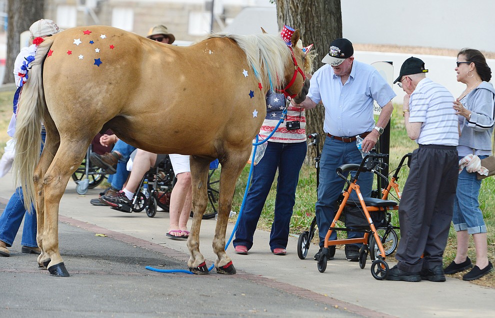 Harley greets Korean War veterans Lars Dohm and Jim Sutton after the Prescott Long Riders rode through the VA Hospital in Prescott Saturday July 27, 2019. (Les Stukenberg/Courier)