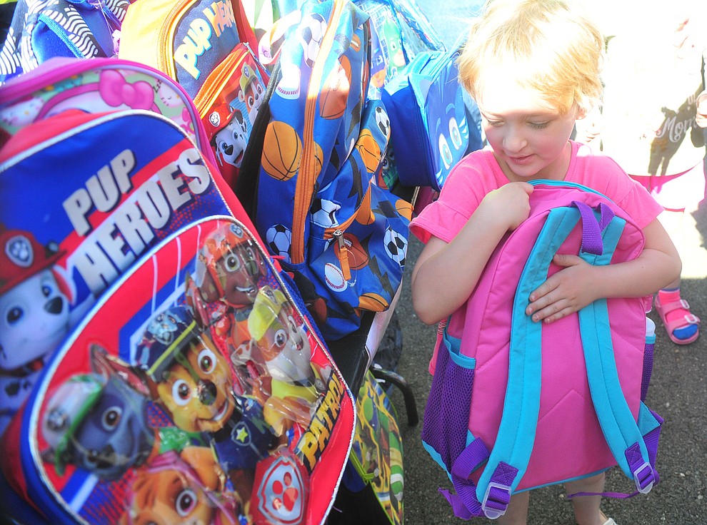 Prescott Valley's Emily Payne finds her backpack as the Yavapai Food Bank gave away 1300 backpacks in the parking lot of Findlay Toyota Center Saturday July 27, 2019 in Prescott Valley. (Les Stukenberg/Courier)