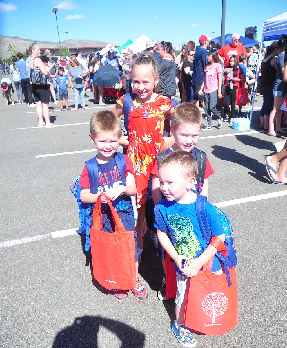 Chino Valley's Mason Parker, Zakary Parker, Brayden Parker and Kaylee Hannah all got their backpacks as the Yavapai Food Bank gave away 1300 backpacks in the parking lot of Findlay Toyota Center Saturday July 27, 2019 in Prescott Valley. (Les Stukenberg/Courier)