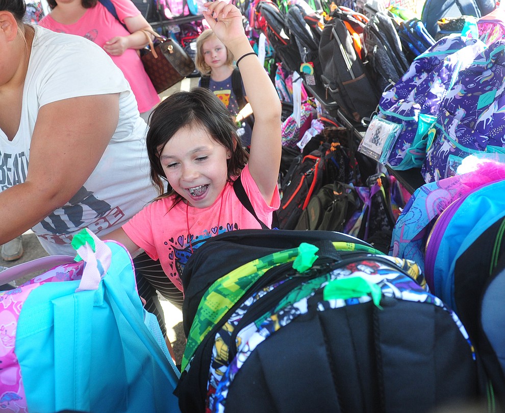 Chino Valley's Elena Canuel scores a backpack as the Yavapai Food Bank gave away 1300 backpacks in the parking lot of Findlay Toyota Center Saturday July 27, 2019 in Prescott Valley. (Les Stukenberg/Courier)