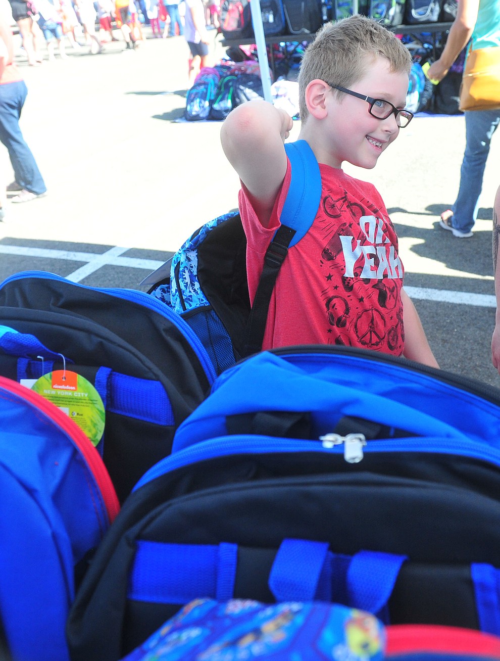Darren Martinez is all smiles after getting his bacpack as the Yavapai Food Bank gave away 1300 backpacks in the parking lot of Findlay Toyota Center Saturday July 27, 2019 in Prescott Valley. (Les Stukenberg/Courier)