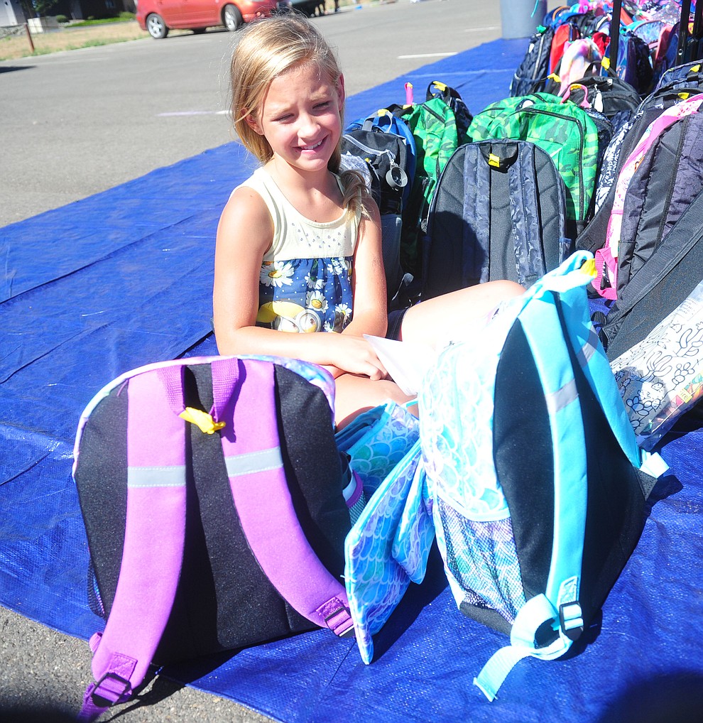 Chino Valley's Allanah Call has to make a decision between two backpacks as the Yavapai Food Bank gave away 1300 backpacks in the parking lot of Findlay Toyota Center Saturday July 27, 2019 in Prescott Valley. (Les Stukenberg/Courier)