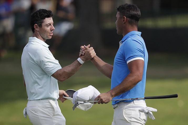 Rory McIlroy, of Northern Ireland, left, shakes hands Brooks Koepka after Koepka won the final round of the World Golf Championships-FedEx St. Jude Invitational, Sunday, July 28, 2019, in Memphis, Tenn. (Mark Humphrey/AP)