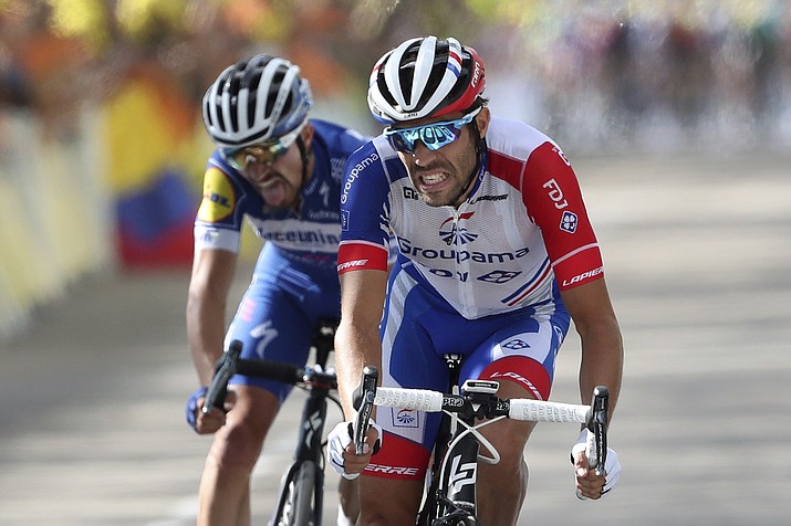 In this Saturday, July 13, 2019 file photo France's Thibaut Pinot, right, and France's Julian Alaphilippe crosse the finish line of the eighth stage of the Tour de France cycling race over 200 kilometers (125 miles) with start in Macon and finish in Saint Etienne, France. (Thibault Camus/AP, file)