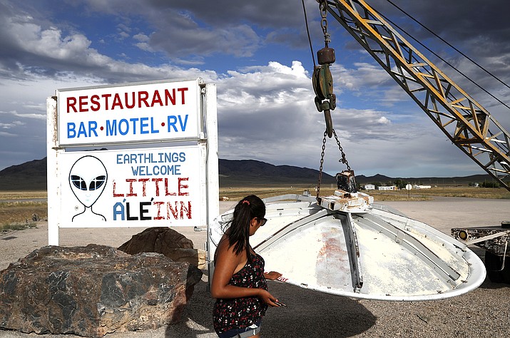 Grace Capati looks at a UFO display outside of the Little A’Le’Inn, in Rachel, Nev., the closest town to Area 51. The U.S. Air Force has warned people against participating in an internet joke suggesting a large crowd of people “storm Area 51,” the top-secret Cold War test site in the Nevada desert. (John Locher/Associated Press)