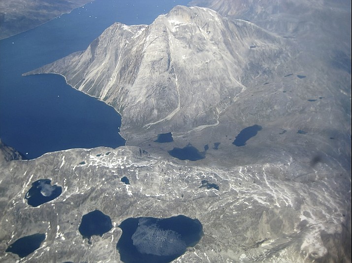 In this image taken on June 22, 2019 an aerial view of melt water lakes on the edge of an ice cap in Nunatarssuk, Greenland. Milder weather than normal since the start of summer, led to the UN's weather agency voicing concern that the hot air which produced the recent extreme heat wave in Europe could be headed toward Greenland where it could contribute to increased melting of ice. (AP Photo/Sandy Virgo)