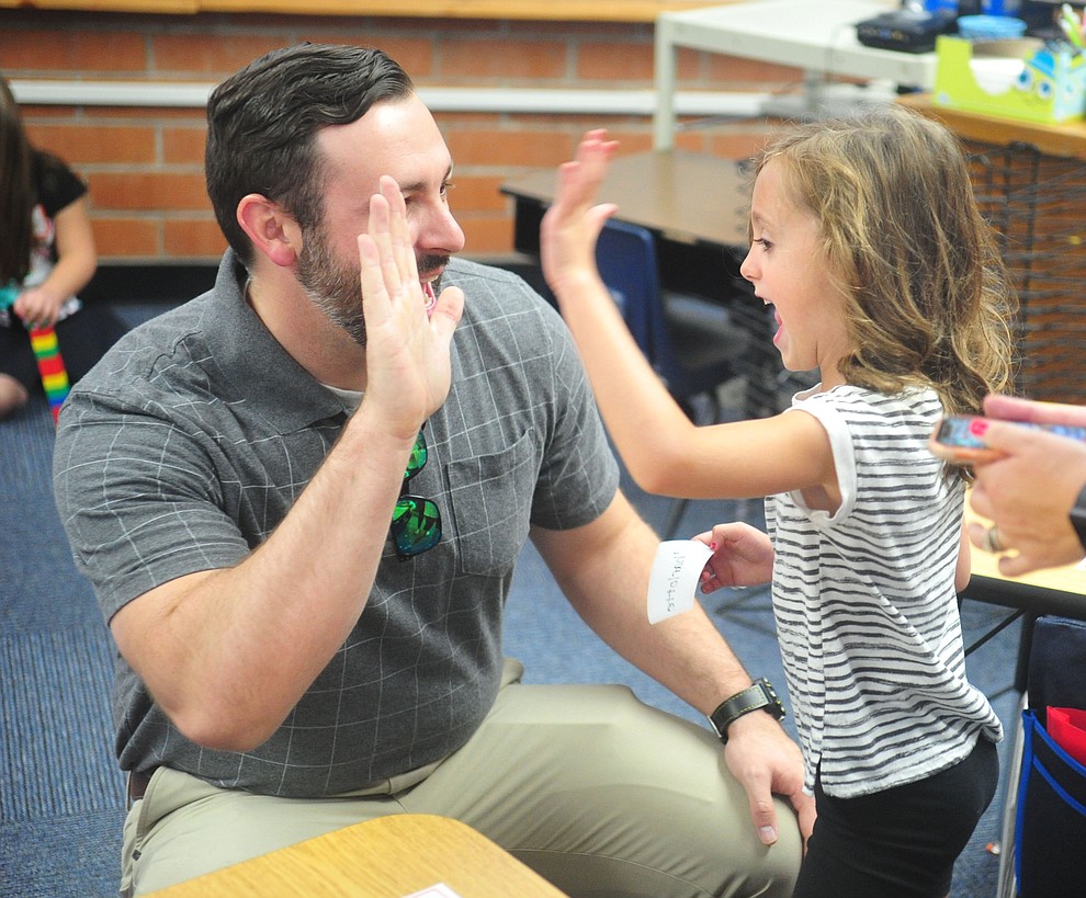 Steven Shepherd gets a high five from daughter Charlotte for the first day of school in kindergarten at Taylor Hicks Elementary School in Prescott Thursday, August 1, 2019. (Les Stukenberg/Courier)