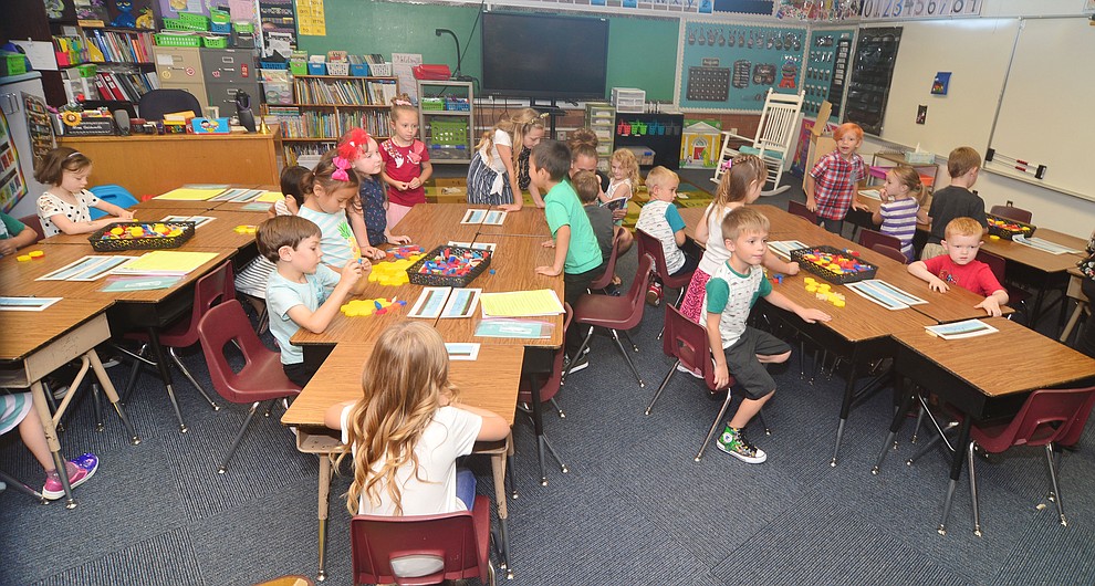 To their seats for the first day of school in kidergarten at Taylor Hicks Elementary School in Prescott Thursday, August 1, 2019. (Les Stukenberg/Courier)