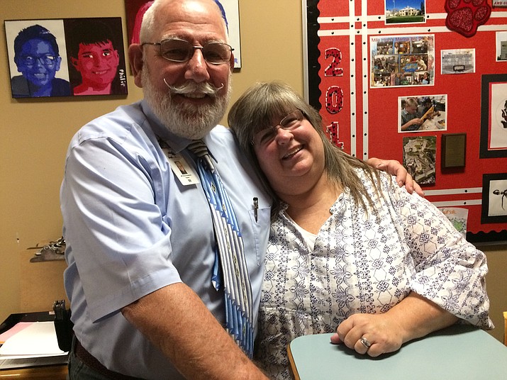 Mile High Middle School industrial arts/applied technology teacher Terry Pemberton, starting his 49th year in the district, with administrative assistant Tracy Courson in the school office. (Nanci Hutson/Courier)