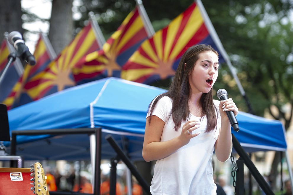 Kayla Rivera sings the National Anthem before Road One South plays for the National Night Out Kickoff on the Yavapai County Courthouse plaza Friday, August 2, 2019, in downtown Prescott. (Les Stukenberg/Courier)