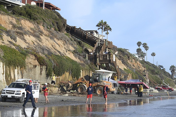 Search and rescue personnel work at the site of a cliff collapse at a popular beach Friday, Aug. 2, 2019, in Encinitas, Calif. At least one person was reportedly killed, and multiple people were injured, when an oceanfront bluff collapsed Friday at Grandview Beach in the Leucadia area of Encinitas, authorities said.(Denis Poroy/AP)